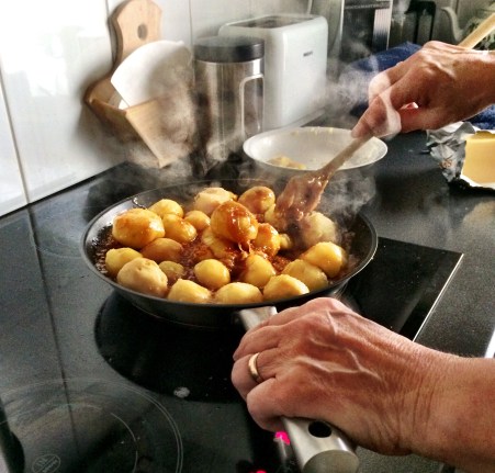 Boiled potatoes are added to a sticky caramel