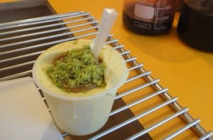 Saffron and seasame seed ice-cream with salty caramel sauce and pistachio crumbs