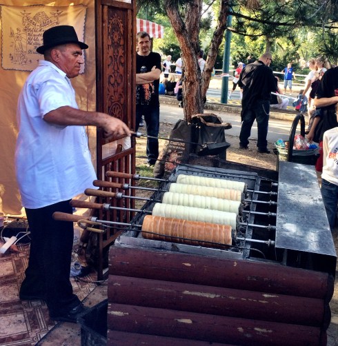 Kürtőskalács are spit roasted over the coal fire